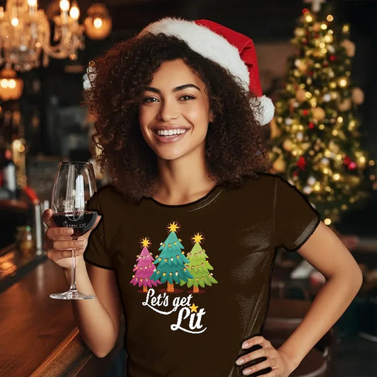 Woman wearing a Santa hat and 'Let's get Lit' shirt, holding a glass of wine in a festive setting. Glass has lit-tees.com printed on it.