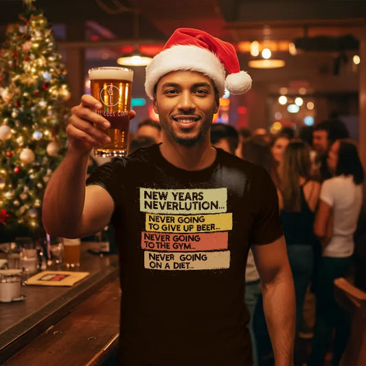 Man wearing a Christmas themed shirt with New Year's Neverlution text, holding a glass of beer in a festive setting. Glass has lit-tees.com printed on it.