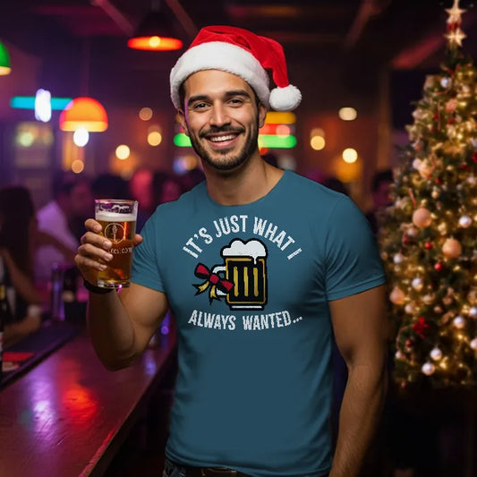 Man wearing a Santa hat and blue t-shirt reading 'Just what I always wanted' holding a beer in a bar setting.