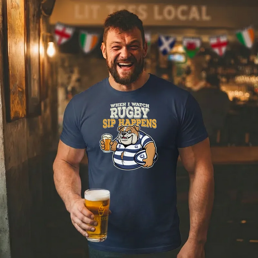 Man wearing a blue t-shirt with rugby-themed design and text saying 'When I watch Rugby sip happens' holding a beer in a bar.