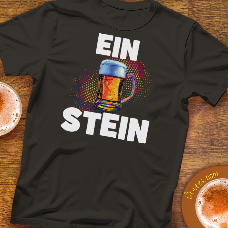 Black t-shirt with 'Ein Stein' design featuring a colorful glass of beer on a wooden surface.