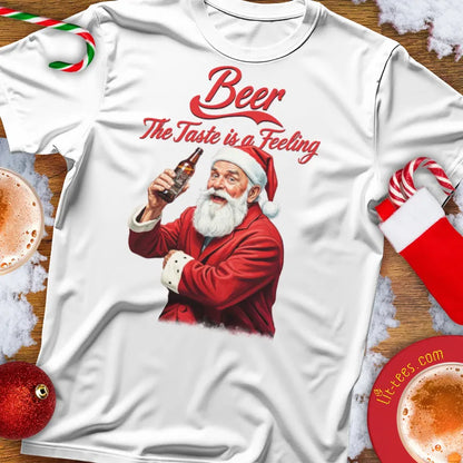 White Christmas t-shirt with Santa Claus holding a beer and text 'Beer The Taste is a Feeling' on a festive background.
