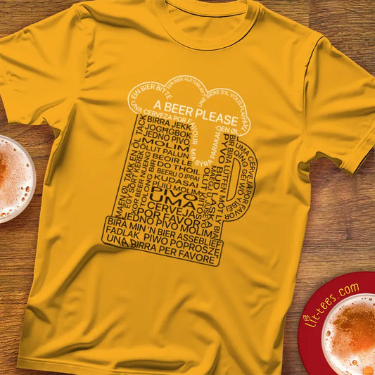 Yellow t-shirt with a beer mug graphic made up of the phrase 1 beer please in multiple languages on a wooden pub table with drinks.