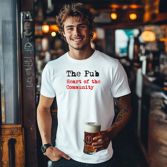 Man wearing a t-shirt with 'The Pub Heart of the Community' text, holding a beer in a bar setting.
