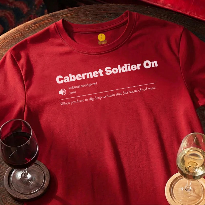 Red t-shirt with 'Cabernet Soldier On' text, wine glasses on a wooden surface