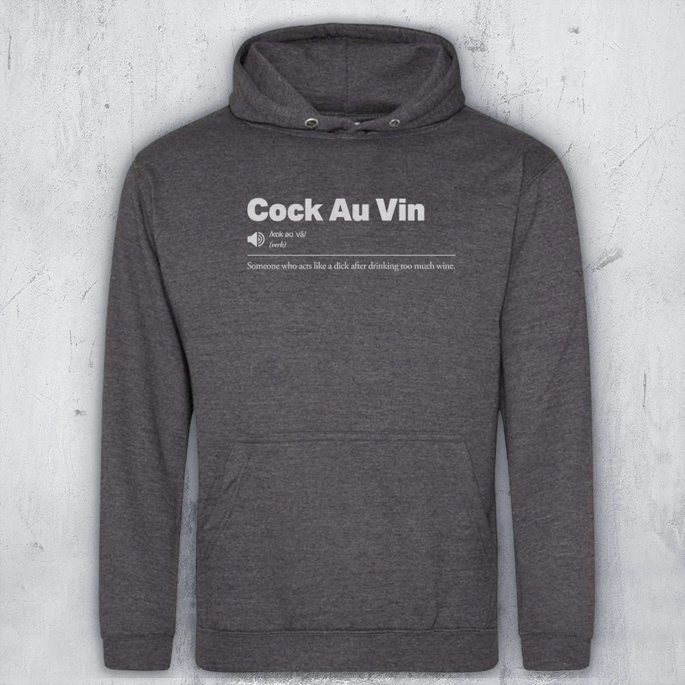 A dark heather gray pullover hoodie with a white graphic text print on the chest reading 'Cock Au Vin' and a small definition-style subtitle, shown against a light gray textured wall background.