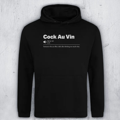 A black pullover hoodie with white printed text on the chest reading 'Cock Au Vin' and a humorous definition underneath, displayed against a textured light gray background.