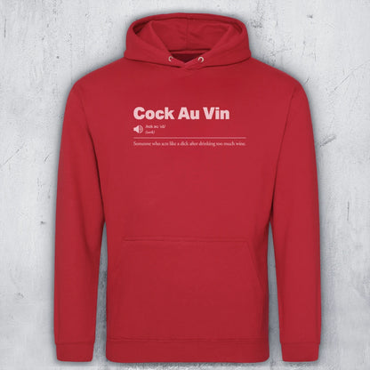 A red pullover hoodie with a white graphic print on the chest reading 'Cock Au Vin'  and a humorous definition underneath, displayed against a textured gray concrete wall.