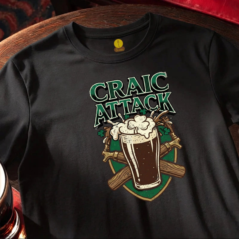 Black t-shirt with 'Craic Attack' design featuring a glass of beer and crossed sticks on a wooden bar table.
