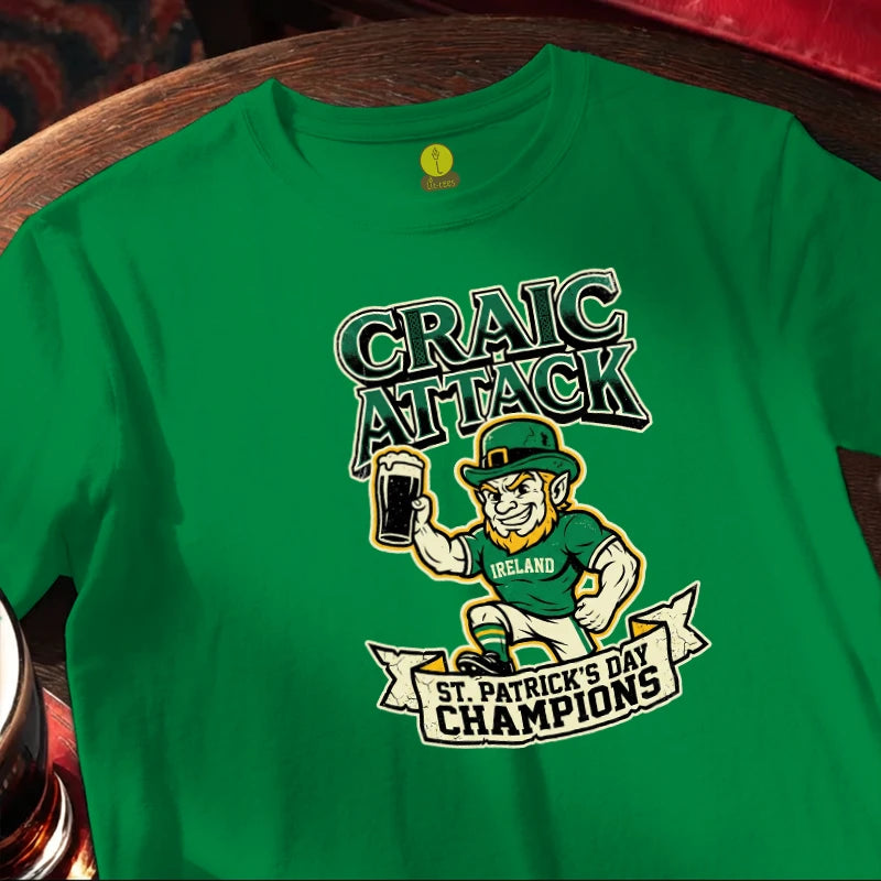 Green t-shirt with 'Craic Attack' and 'St. Patrick's Day Champions' design on a wooden bar table.