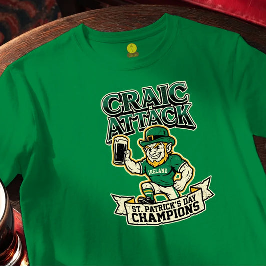Green t-shirt with 'Craic Attack' and 'St. Patrick's Day Champions' design on a wooden bar table.