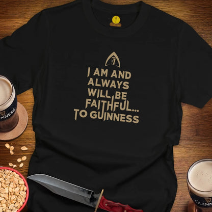 A black short-sleeve t-shirt with a gold graphic print reading 'I AM AND ALWAYS WILL BE FAITHFUL TO GUINNESS'.