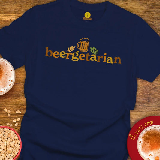 A navy blue t-shirt with a gold 'beergetarian' graphic printed on the chest, styled in a flat-lay on a wooden table with beer glasses and peanuts.