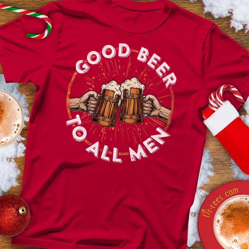 Red Christmas t-shirt with 'Good Beer to All Men' graphic on a festive background with candy canes and hot chocolate.