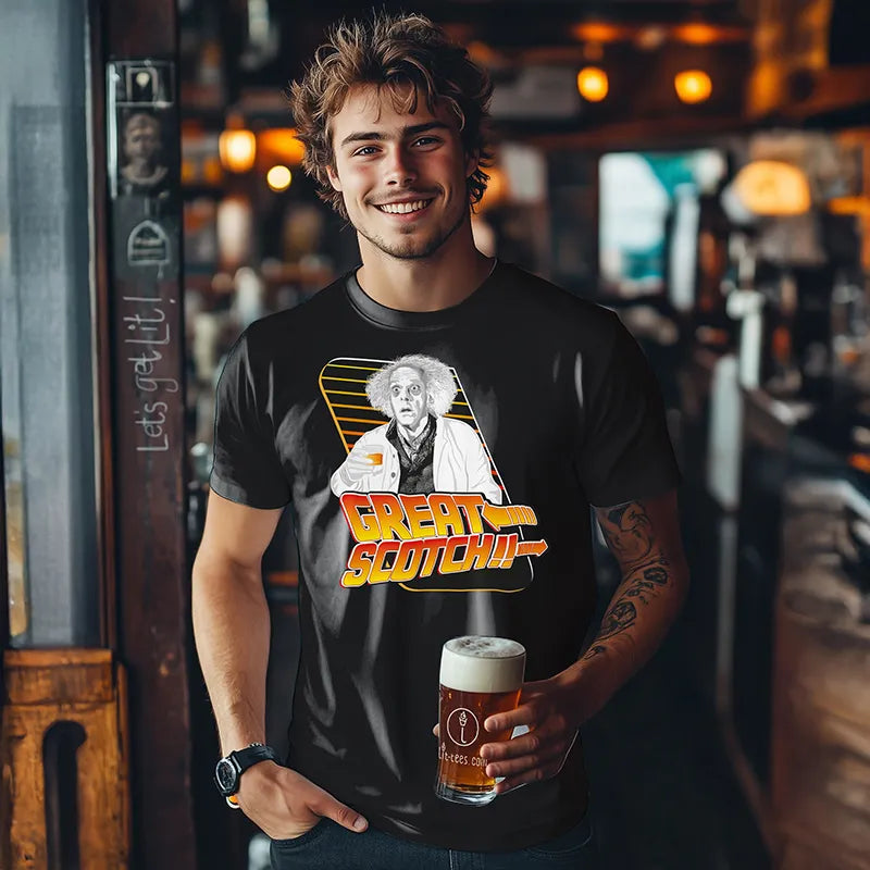 Man wearing a t-shirt with 'Great Scotch' design holding a drink in a bar setting