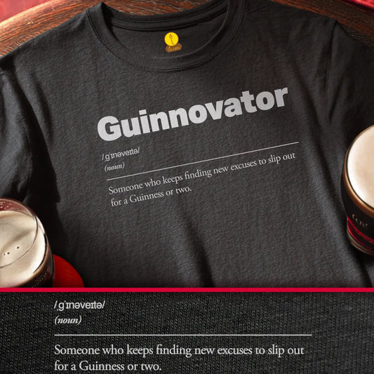 Black t-shirt with 'Guinnovator' text and definition, placed on a wooden surface with Guinness pints