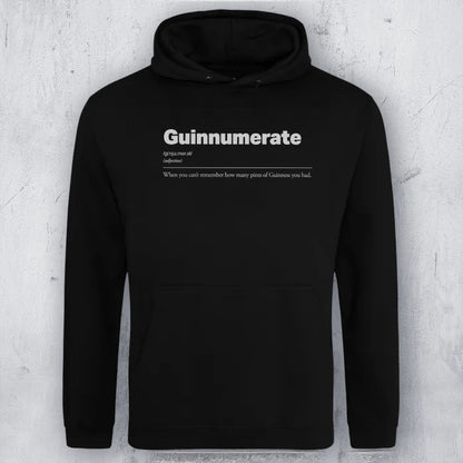 A black pullover hoodie with a white printed graphic on the chest reading 'Guinnumerate' and a dictionary-style definition underneath, shown against a light gray textured wall.