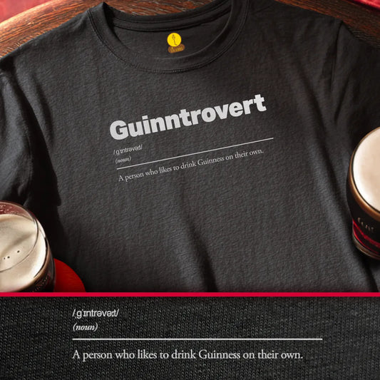 Black t-shirt with 'Guinntrovert' text design, sitting on a wooden surface with Guinness pints.