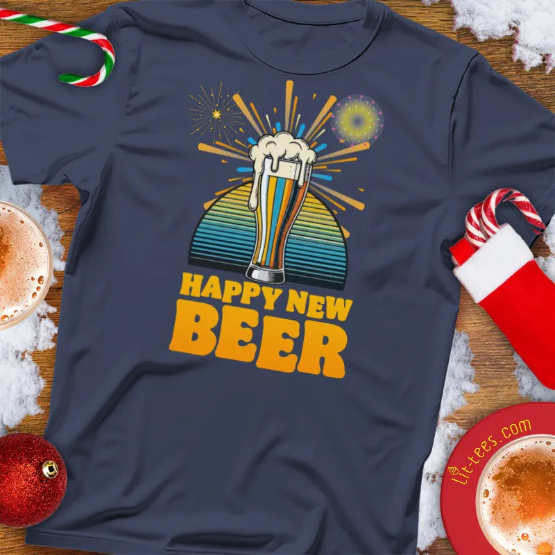 Navy blue Christmas t-shirt with 'Happy New Beer' design on a festive background with drinks and decorations.