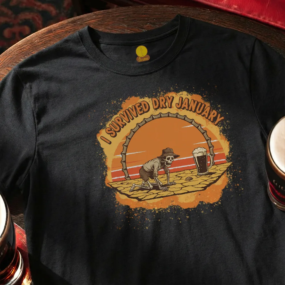 Black t-shirt with a graphic of a skeleton and 'I Survived Dry January' text on a wooden bar table.