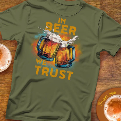 Green t-shirt with beer-themed design and text 'In Beer We Trust' on a wooden surface.