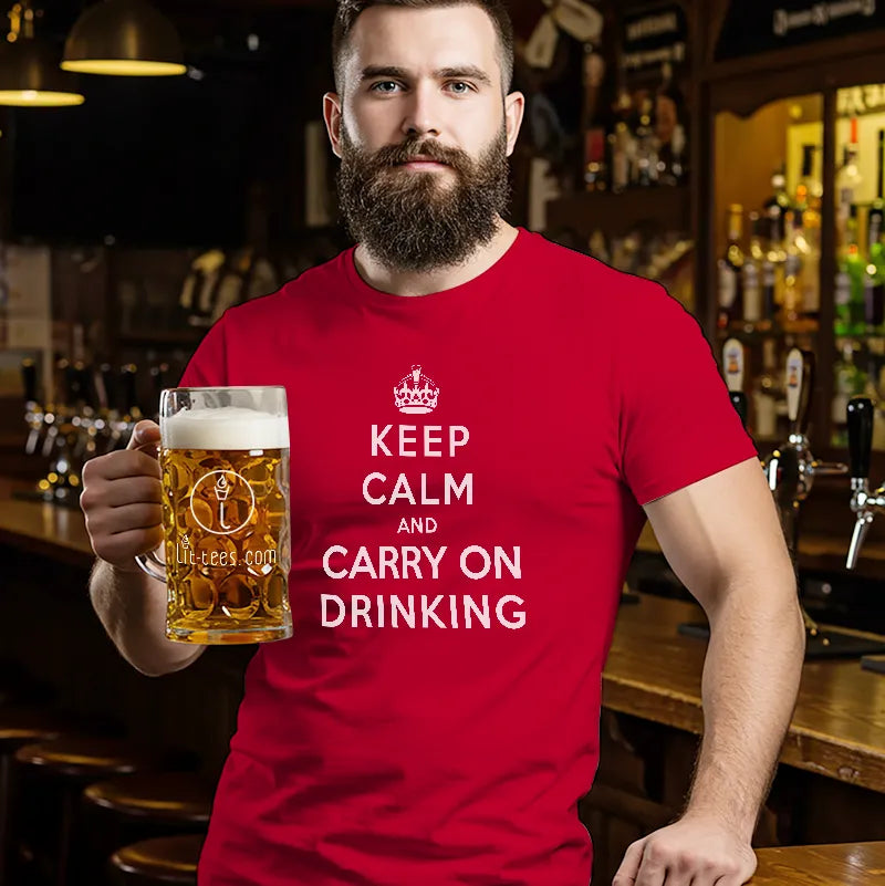 Man in bar wearing a red t-shirt holding a beer with a humorous message saying 'Keep Calm and Carry On Drinking' 