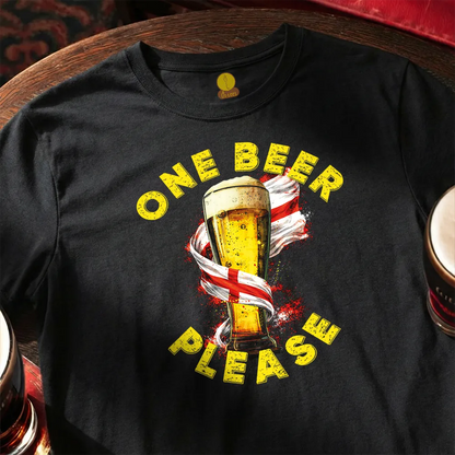 Black t-shirt with a graphic of a beer glass and 'One Beer Please' text on a wooden surface.