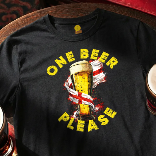 Black t-shirt with a graphic of a beer glass and 'One Beer Please' text on a wooden surface.