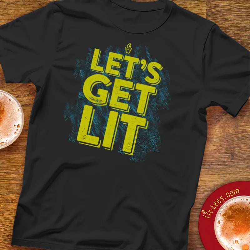 Black t-shirt with 'LET'S GET LIT' text on a wooden surface with pints of beer.