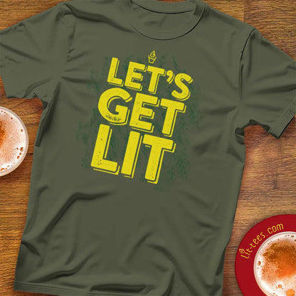 Green t-shirt with 'LET'S GET LIT' text on a wooden pub table with drinks.