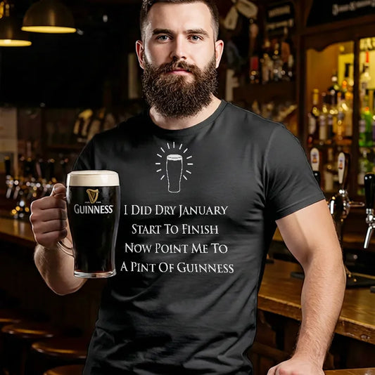 Man holding a pint of Guinness wearing a t-shirt with a humorous Dry January message in a bar setting.