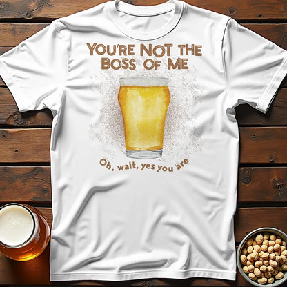 White tee shirt with a beer image and humorous text saying 'You're not the boss of me... oh, wait, yes you are' on wooden surface with beer glasses.