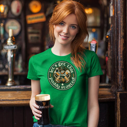 Girl in a bar holding a pint of Guinness wearing a green t-shirt with text saying 'Let's Get this Paddy Started'