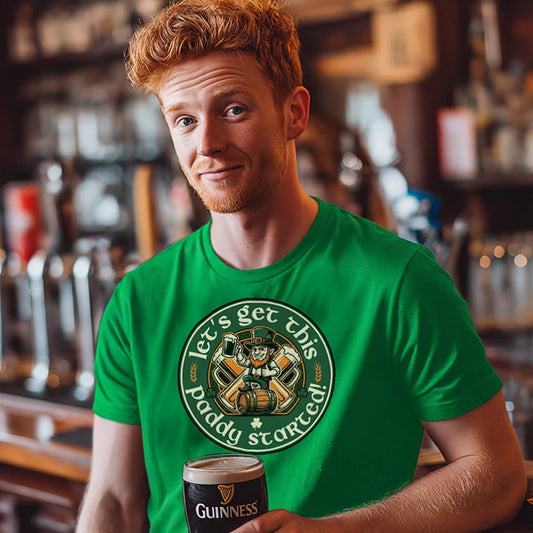 Man in a bar holding a pint of Guinness wearing a green t-shirt with text saying 'Let's Get this Paddy Started'