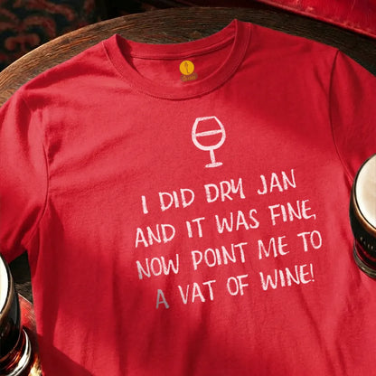 Red t-shirt with humorous text and wine glass graphic on a wooden bar table with glasses. 