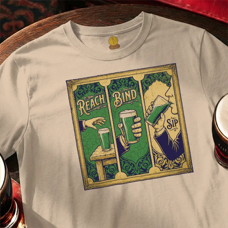 T-shirt with a graphic design of a person holding a beer mug and text 'Reach Bind' on a wooden bar table.