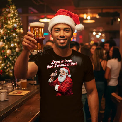 Man in bar wearing Santa hat, holding a beer and wearing a T Shirt with text saying 'Does it look like I drink Milk?'