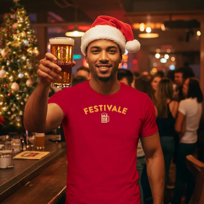 Man in a red Christmas themed 'Festivale' t-shirt and Santa hat holding a beer in a festive bar setting. Glass has lit-tees.com printed on it.