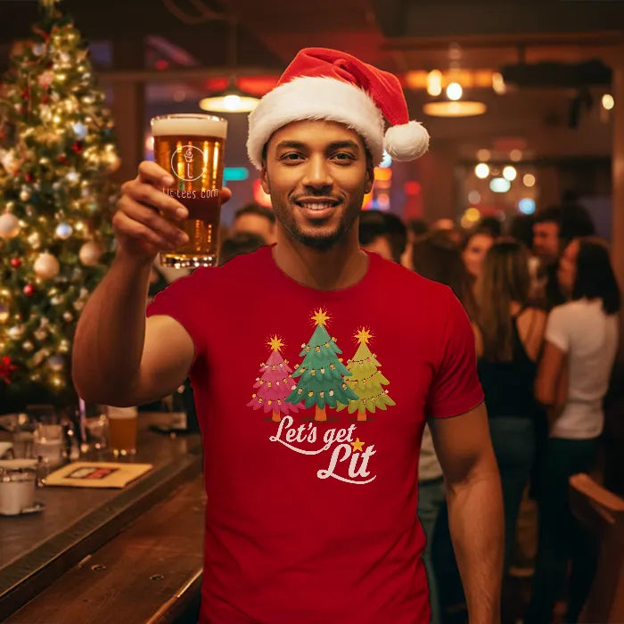 Man wearing a Santa hat and Christmas-themed shirt reading, Let's get Lit, holding a beer in a festive bar setting. Glass has lit-tees.com printed on it.