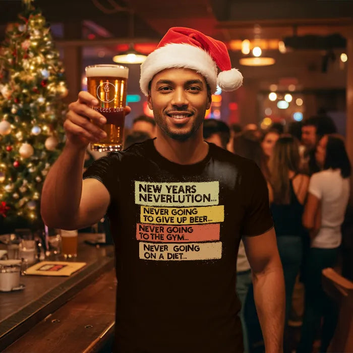 Man wearing a Christmas themed shirt with New Year's Neverlution text, holding a glass of beer in a festive setting. Glass has lit-tees.com printed on it.