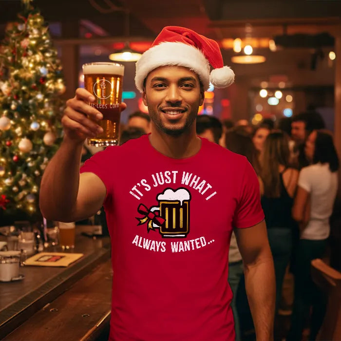Man in a red Christmas Tee Shirt reading 'Just what I always wanted' with a Santa hat holding a beer in a festive bar setting