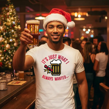 Man in a bar wearing a Santa hat and a festive t-shirt reading 'Just what I always wanted', and holding up a beer with lit-tees.com on it.