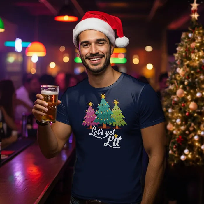 Man wearing a Santa hat and 'Let's get Lit' shirt holding a beer in a festive bar setting. Glass has lit-tees.com printed on it.