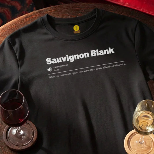 Black t-shirt with 'Sauvignon Blank' text and wine glasses on a wooden bar table.