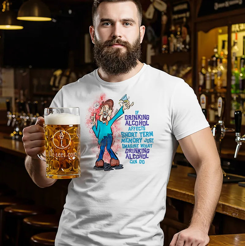Man holding a beer in a bar wearing a white tee shirt with a cartoon character and humorous text saying 'If drinking alcohol affects short term memory just imagine what drinking alcohol can do' 