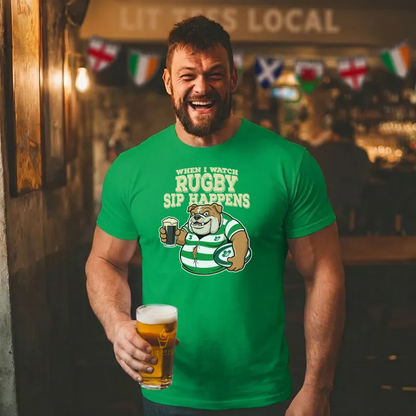 Man wearing a green t-shirt with rugby-themed design and text  saying 'When I watch Rugby, Sip happens' holding a beer in a bar.