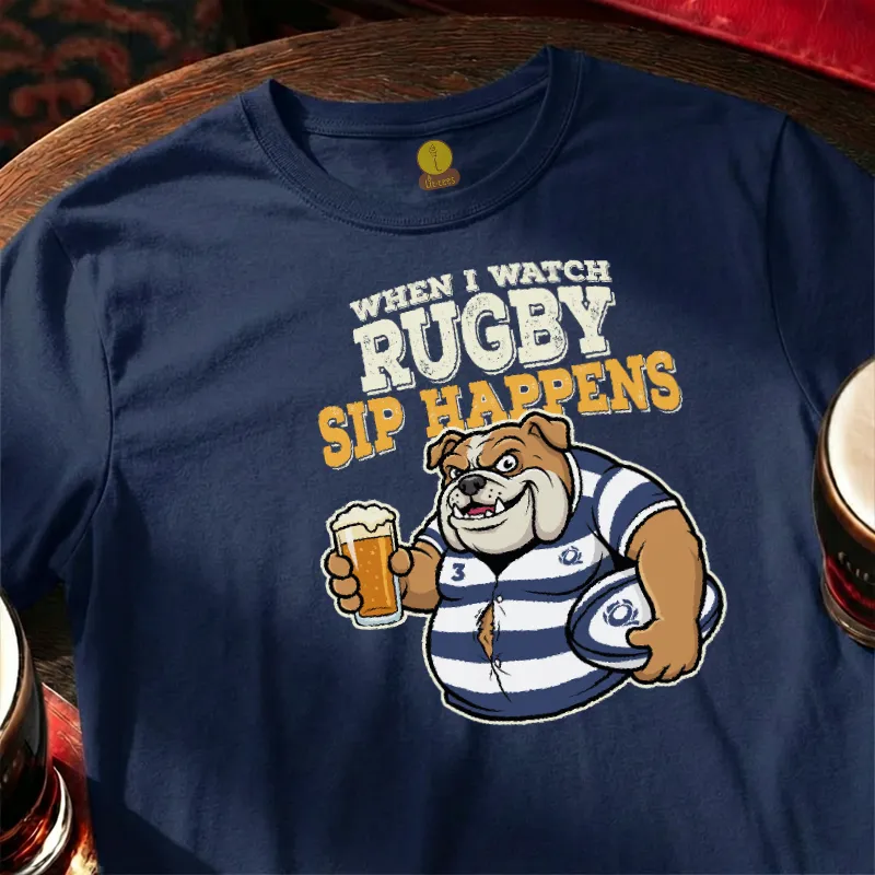 Navy blue t-shirt with rugby-themed graphic and text  saying 'When I watch Rugby, Sip happens' on a wooden bar table