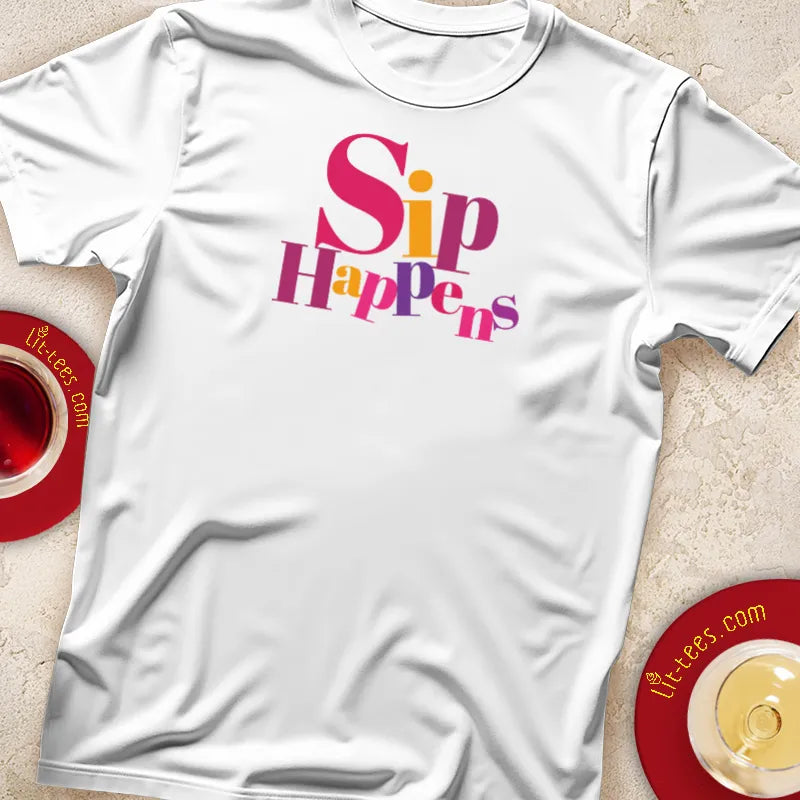 White t-shirt with 'Sip Happens' text, displayed with a cup of tea and saucer.