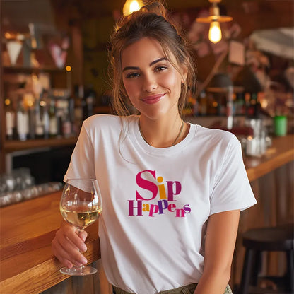 Woman in a bar wearing a 'Sip Happens' t-shirt holding a glass of wine.