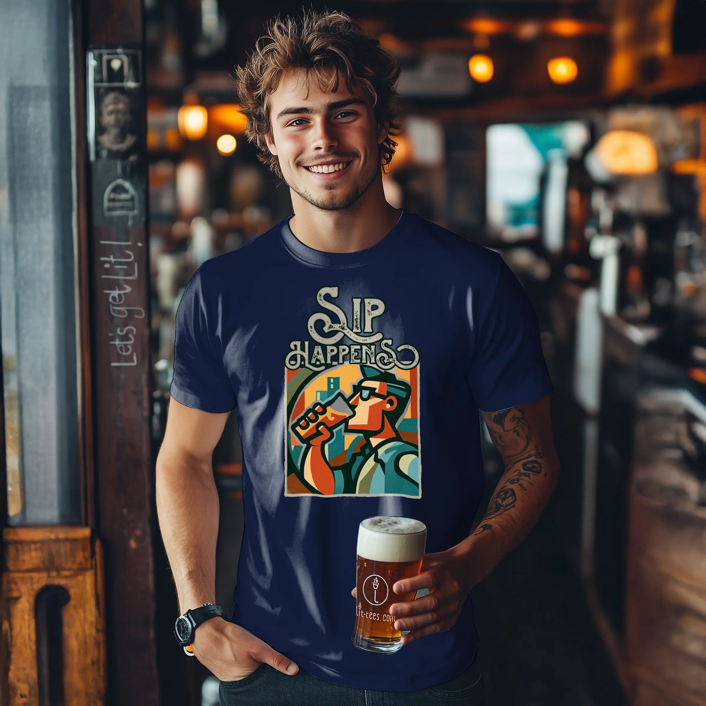 Man wearing a navy blue t-shirt with 'Sip Happens' design, holding a beer in a bar setting.